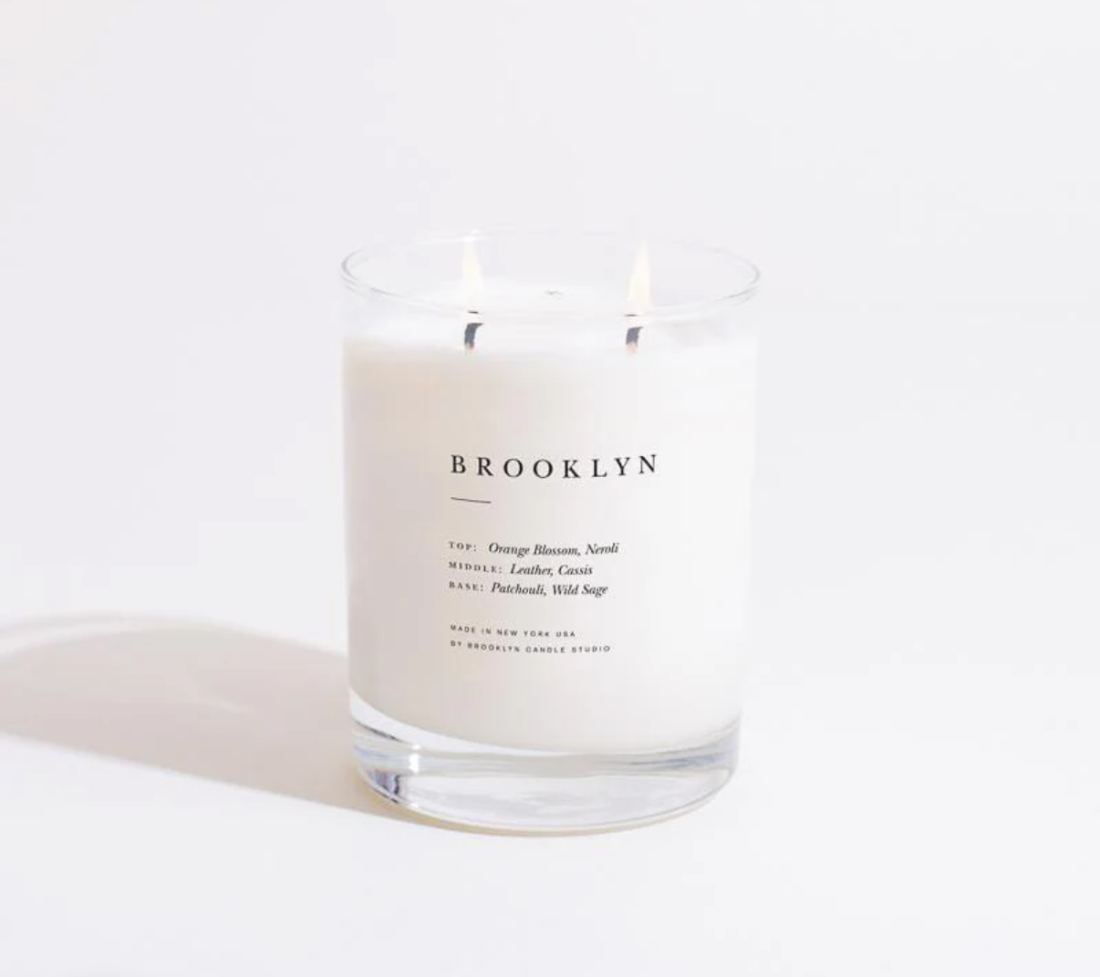 Candle with 'Brooklyn' branding on a white background