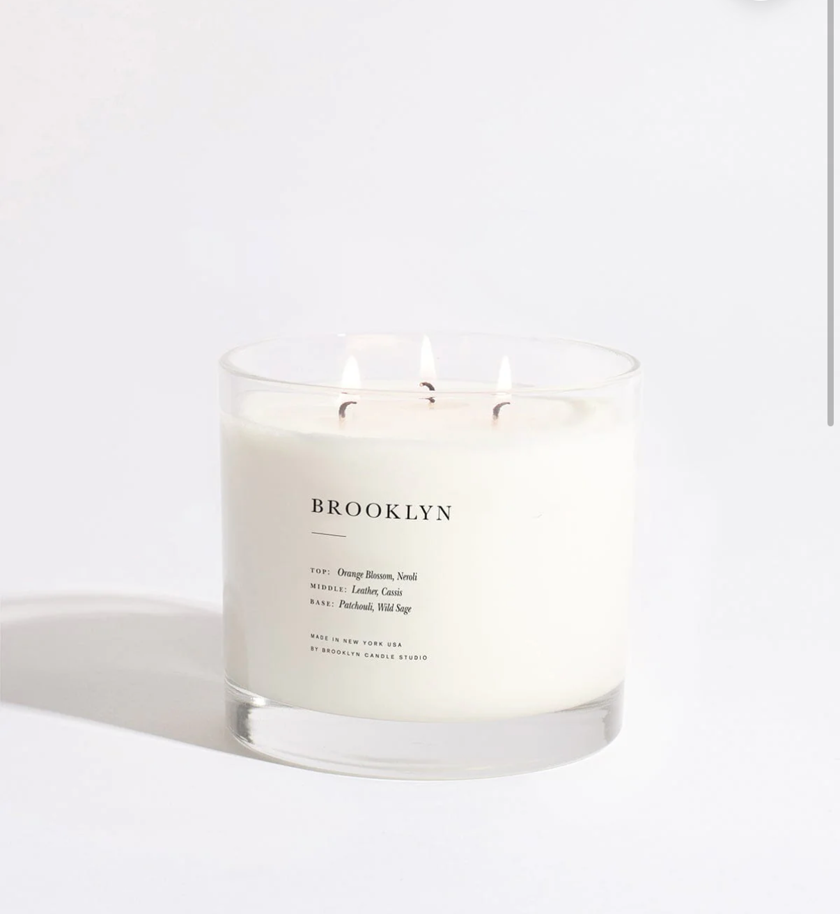 White candle with 'Brooklyn' branding on a white background