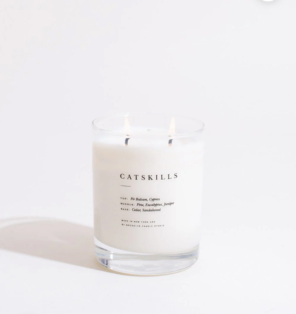 Candle with 'Catskills' label on a white background