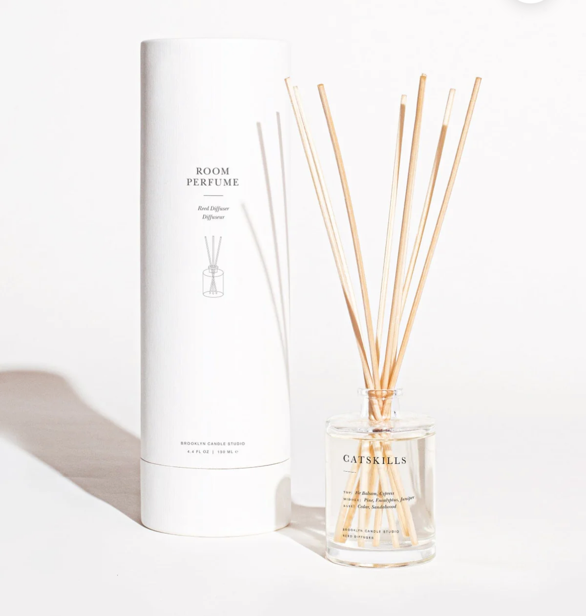 Room perfume with reeds and packaging on a white background