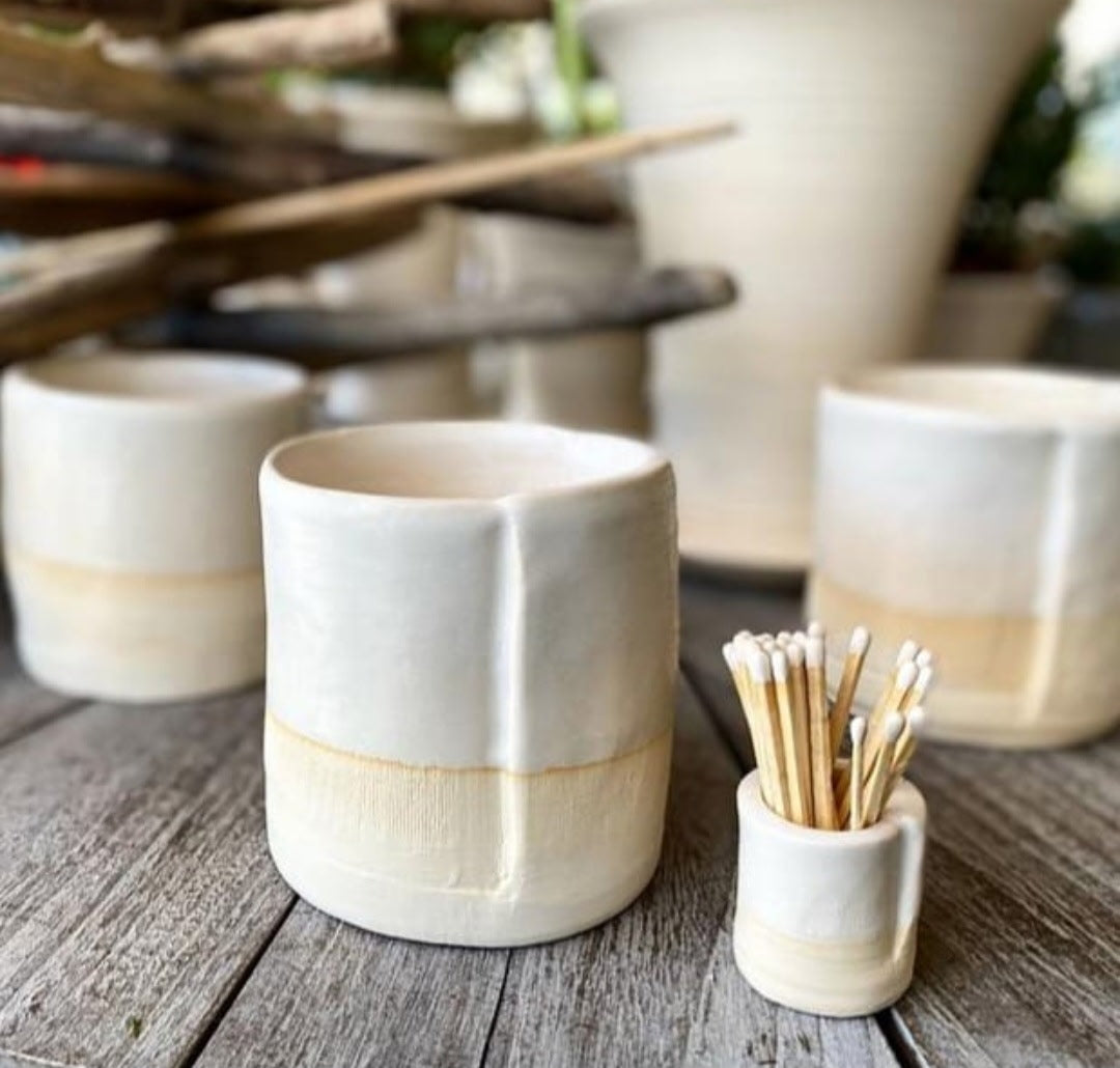 Set of ceramic planters with a toothpick holder on a wooden surface