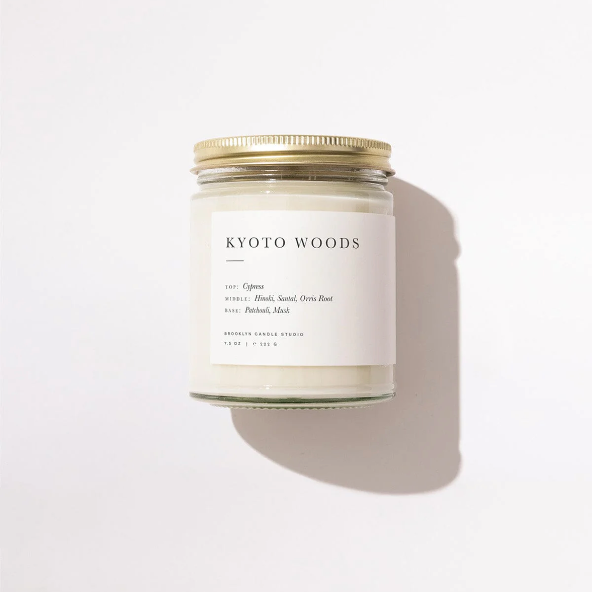 Candle jar with 'Kyoto Woods' label on a white background