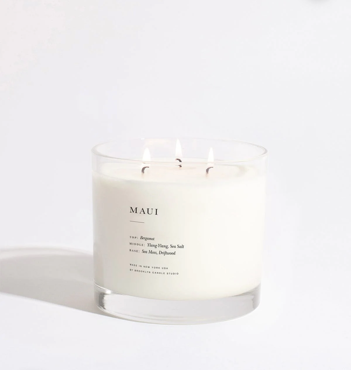 Candle labeled 'MAUI' on a white background
