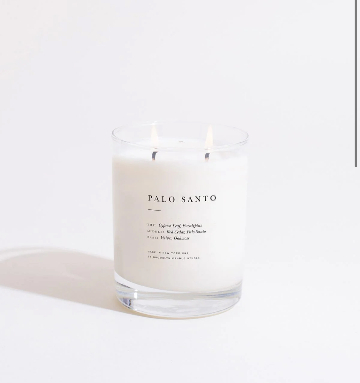 Palo Santo candle in a glass jar on a white background