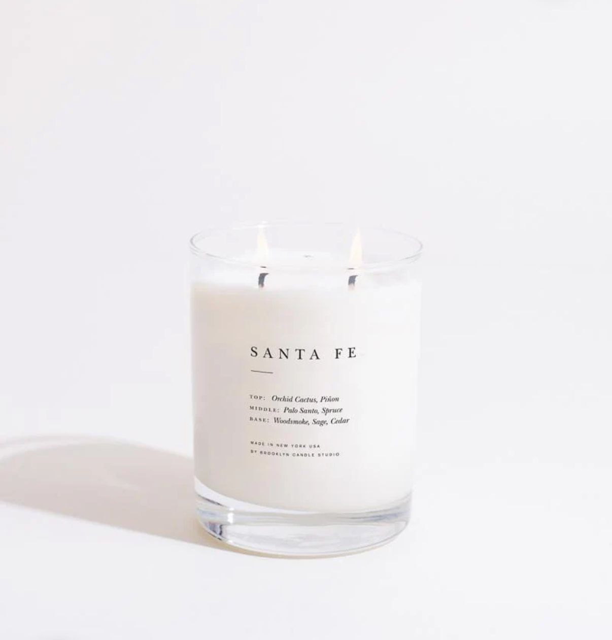 Candle labeled 'Santa Fe' on a white background