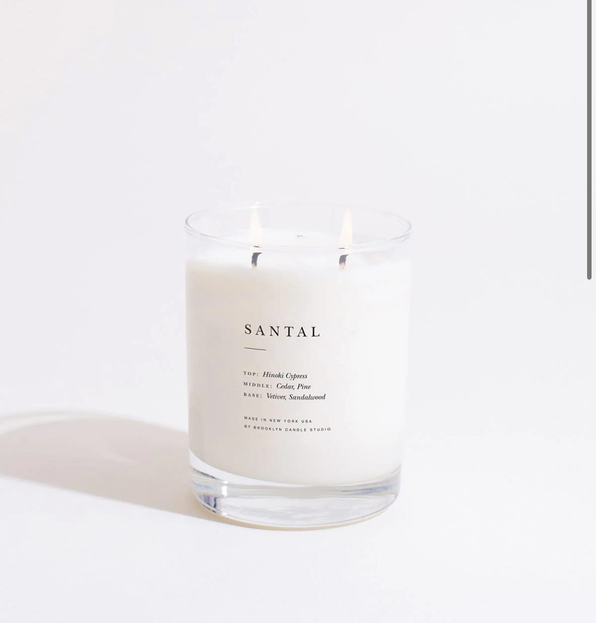 Scented candle labeled 'Santal' on a white background
