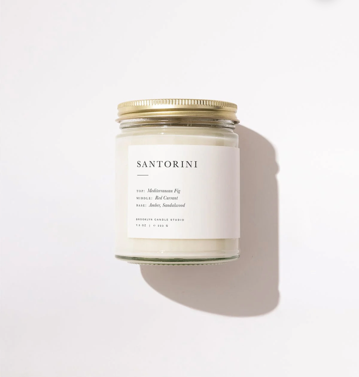 Candle with 'Santorini' branding on a white background