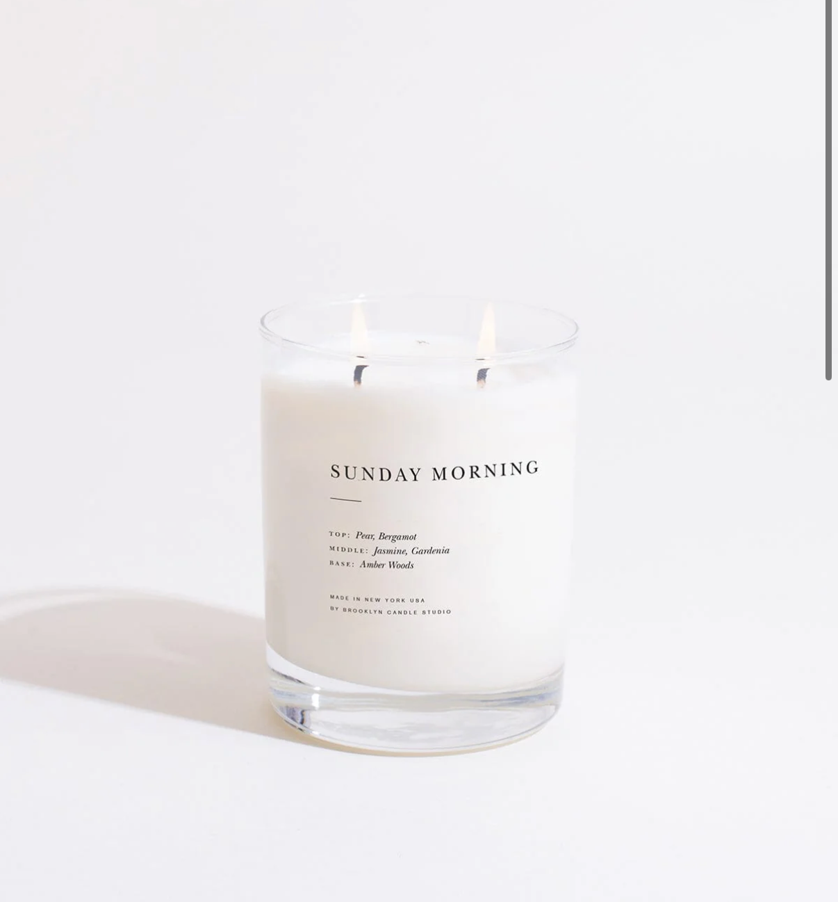 Candle labeled 'Sunday Morning' on a white background