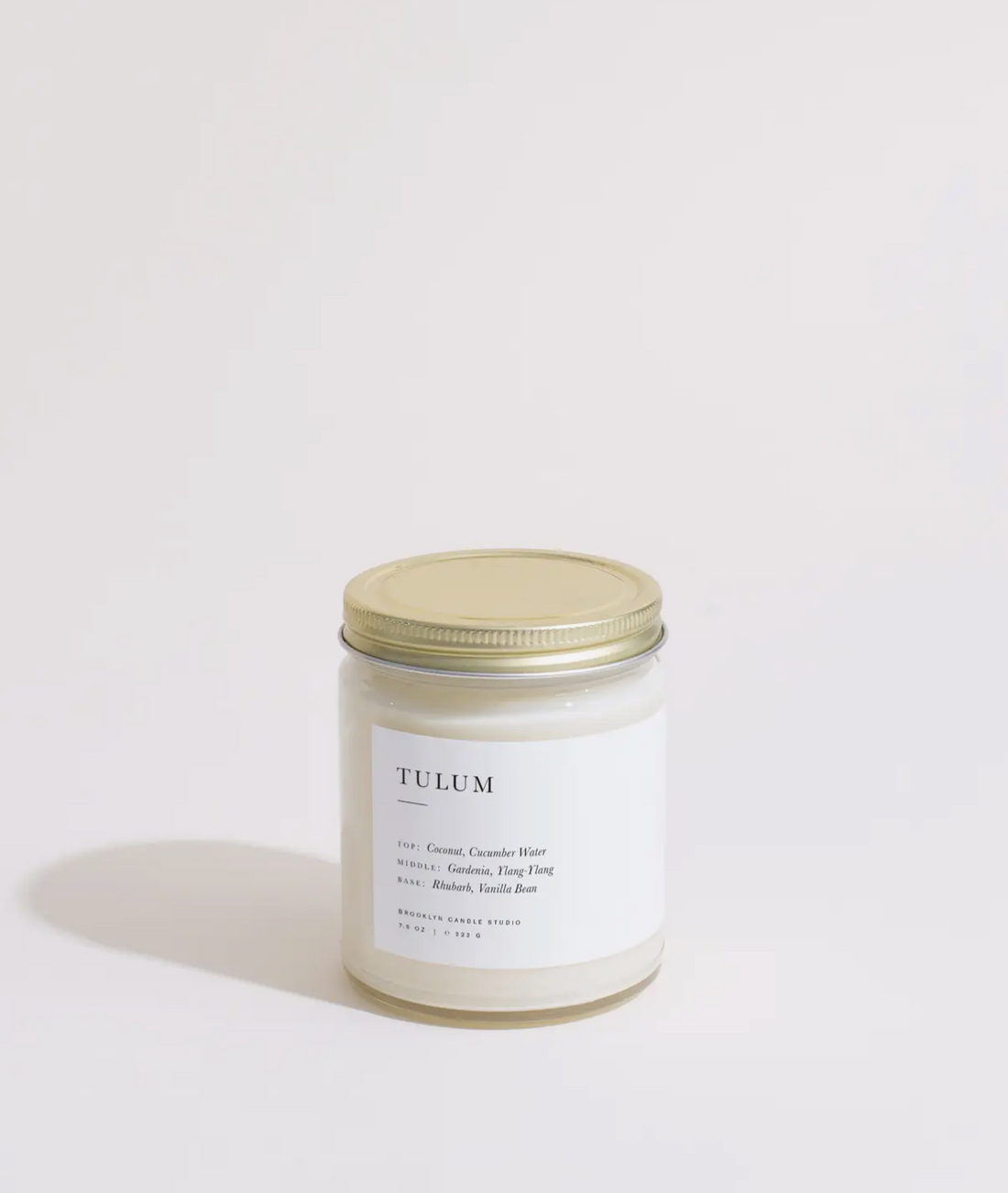 Candle jar labeled 'Tulum' on a light background