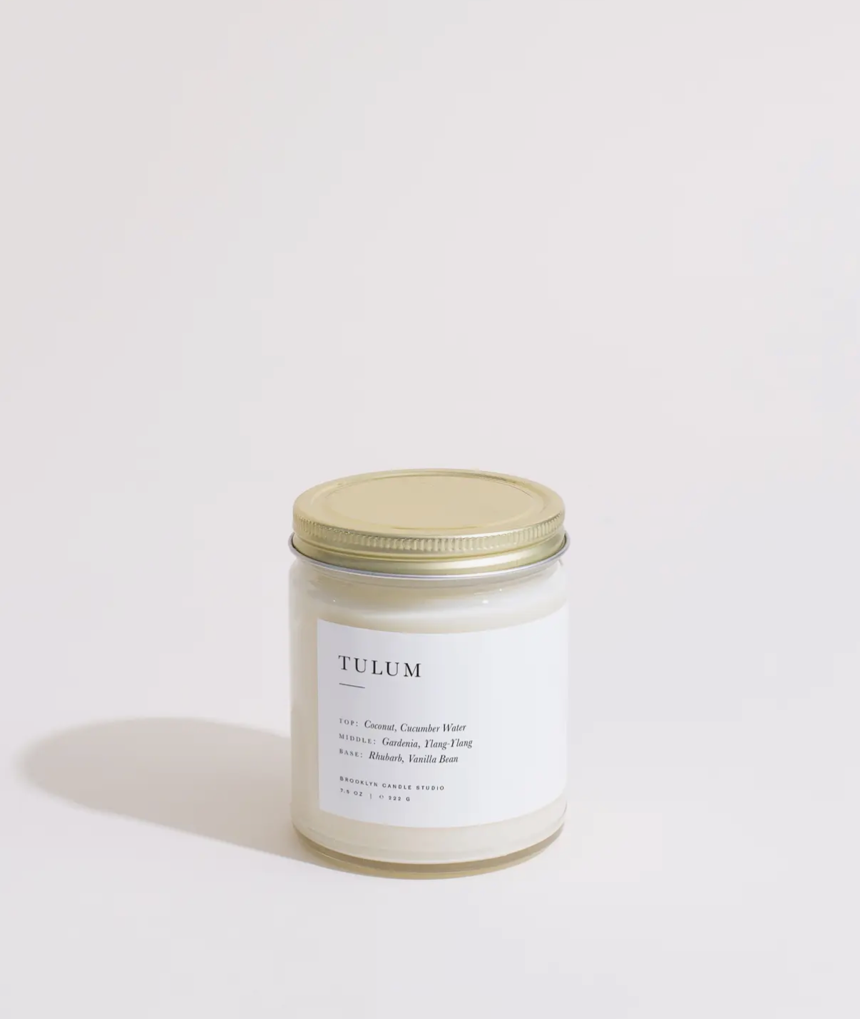 Candle jar labeled 'Tulum' on a light background